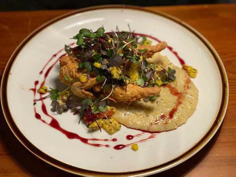 Fried quail / Over polenta with a micro green, corn, and roasted tomato salad on top with pomegranate glaze!