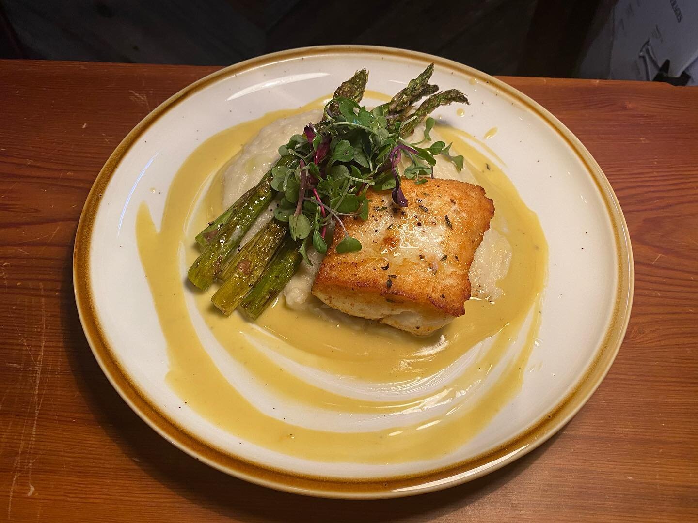 Our catch of the day is Halibut over mashed potatoes with asparagus, and an orange butter sauce.
